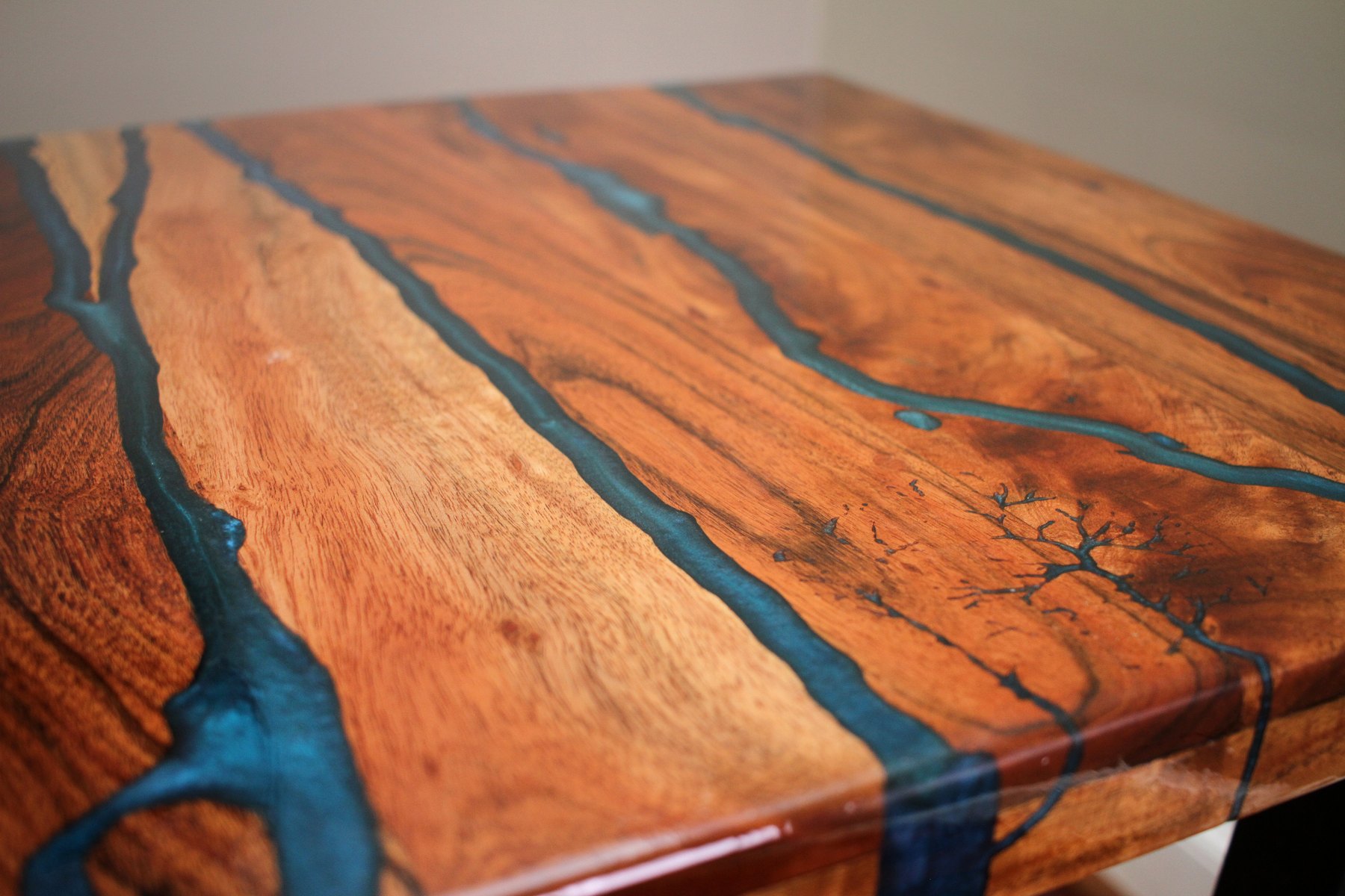 Close detail of figured wood and blue resin